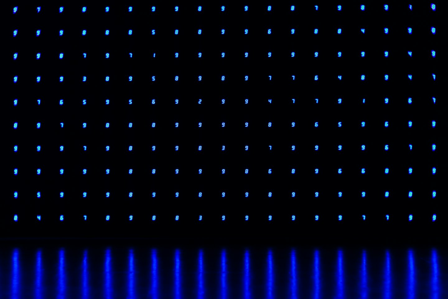 Abstract grid of glowing blue digital numbers on black.